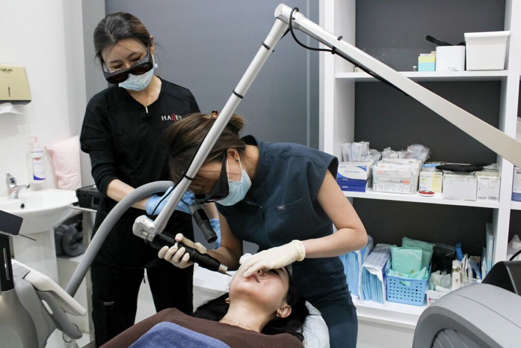 Halley Medical Aestheticsでピコレーザー『PicoSure Pro』の施術を受ける女性。医師が慎重に照射を行い、肌の透明感とハリを引き出す様子。